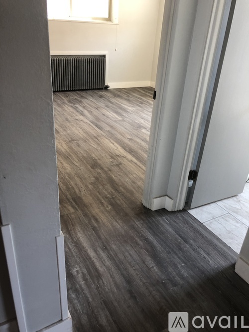 A room with a grey floor and a radiator.