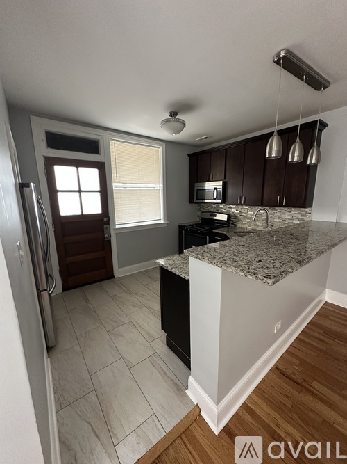 A room with wooden flooring and a ceiling fan.