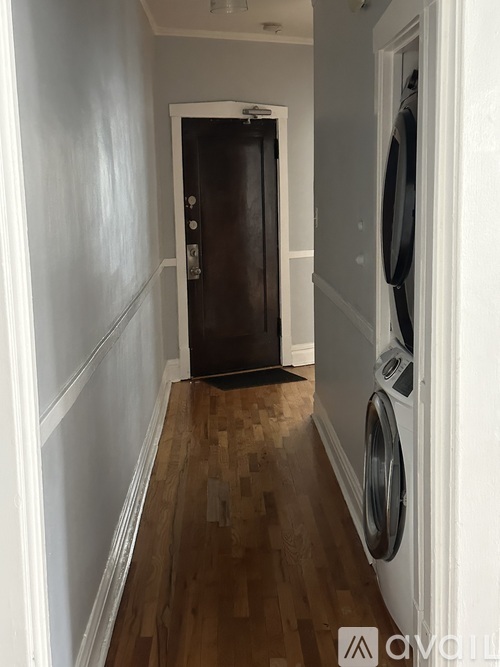 A room with wooden flooring and a large window.