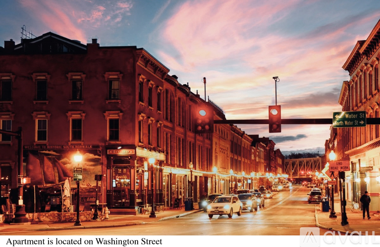 A street view of Washington Street with cars and buildings.