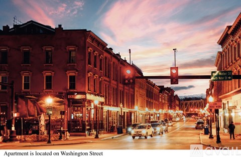 A street view of Washington Street with cars and buildings.