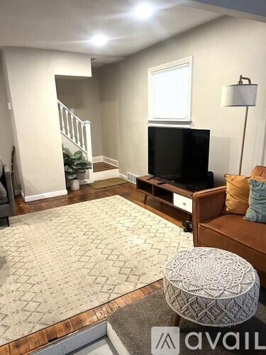 A living room with a television and a couch.