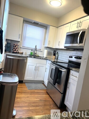 A kitchen with white cabinets and stainless steel appliances.