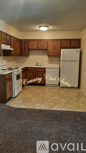 A kitchen with a refrigerator that says Club Suites.