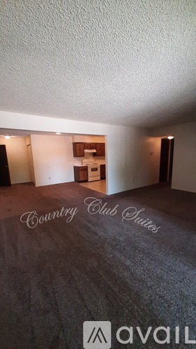 A room with a carpeted floor and a sign that says "Country Club Suites".