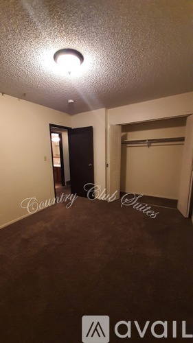 A room with a door and a light on the ceiling.