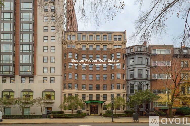 A street view of a building with the text "Boston Proper Real Estate" on it.