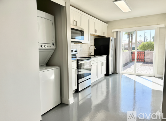A modern kitchen with white appliances and cabinets.