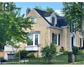 A large house with a black fence in front.