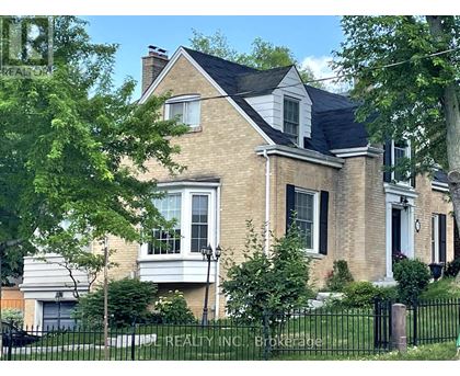 A large house with a black fence in front.