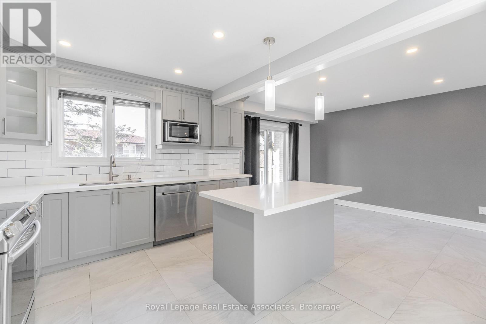 A modern kitchen with a large island in the middle.