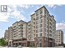 A large, multi-story building with a flat roof and a balcony on the second floor.