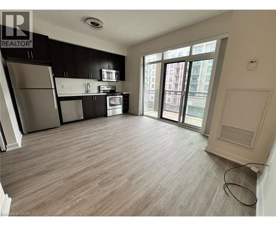 A kitchen with black cabinets and stainless steel appliances.