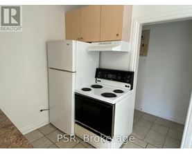 A small kitchen with a white refrigerator and a white stove top oven.