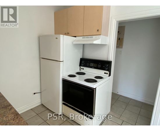 A small kitchen with a white refrigerator and a white stove top oven.