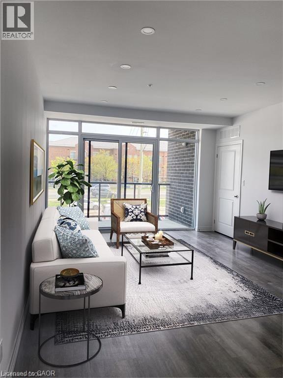 A living room with a white couch, a coffee table, and a large window.