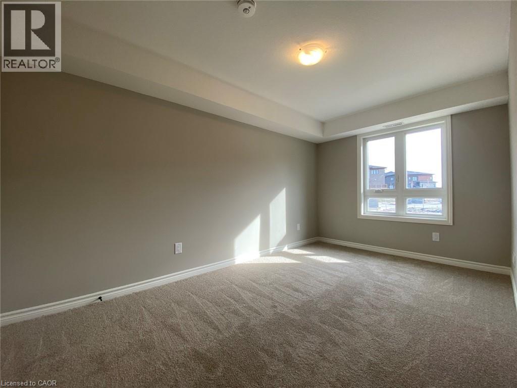 A room with a window and carpeted floor.