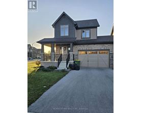 A house with a garage and a driveway in front of it.
