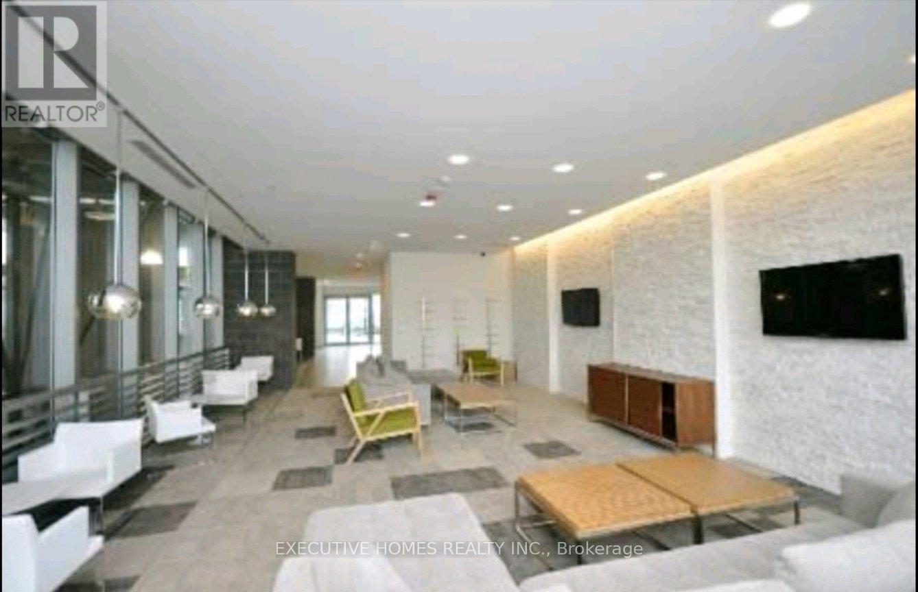 A spacious living room with a white brick wall and a flat screen TV.