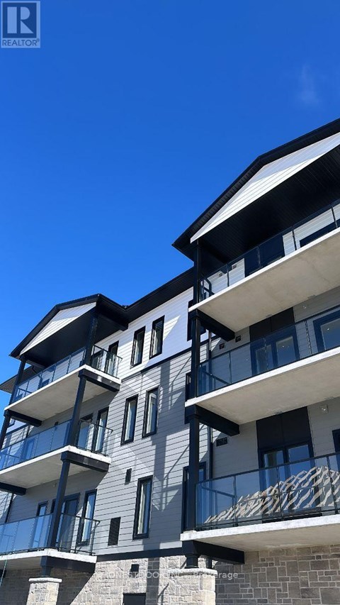 A modern building with balconies and a clear blue sky.