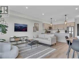 A modern living room with a white sofa, a grey armchair, and a coffee table.