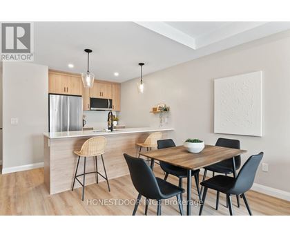 A modern kitchen with a dining table set up.