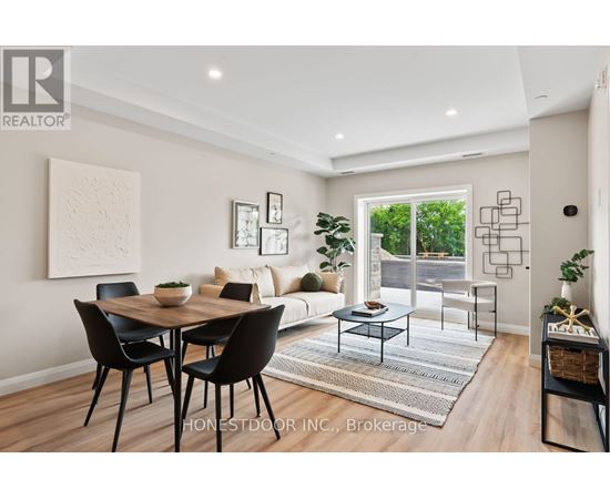 A dining room with a table and chairs.