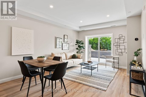 A dining room with a table and chairs.