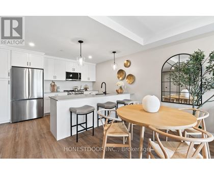 A modern kitchen with a wooden table and chairs.