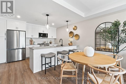 A modern kitchen with a wooden table and chairs.