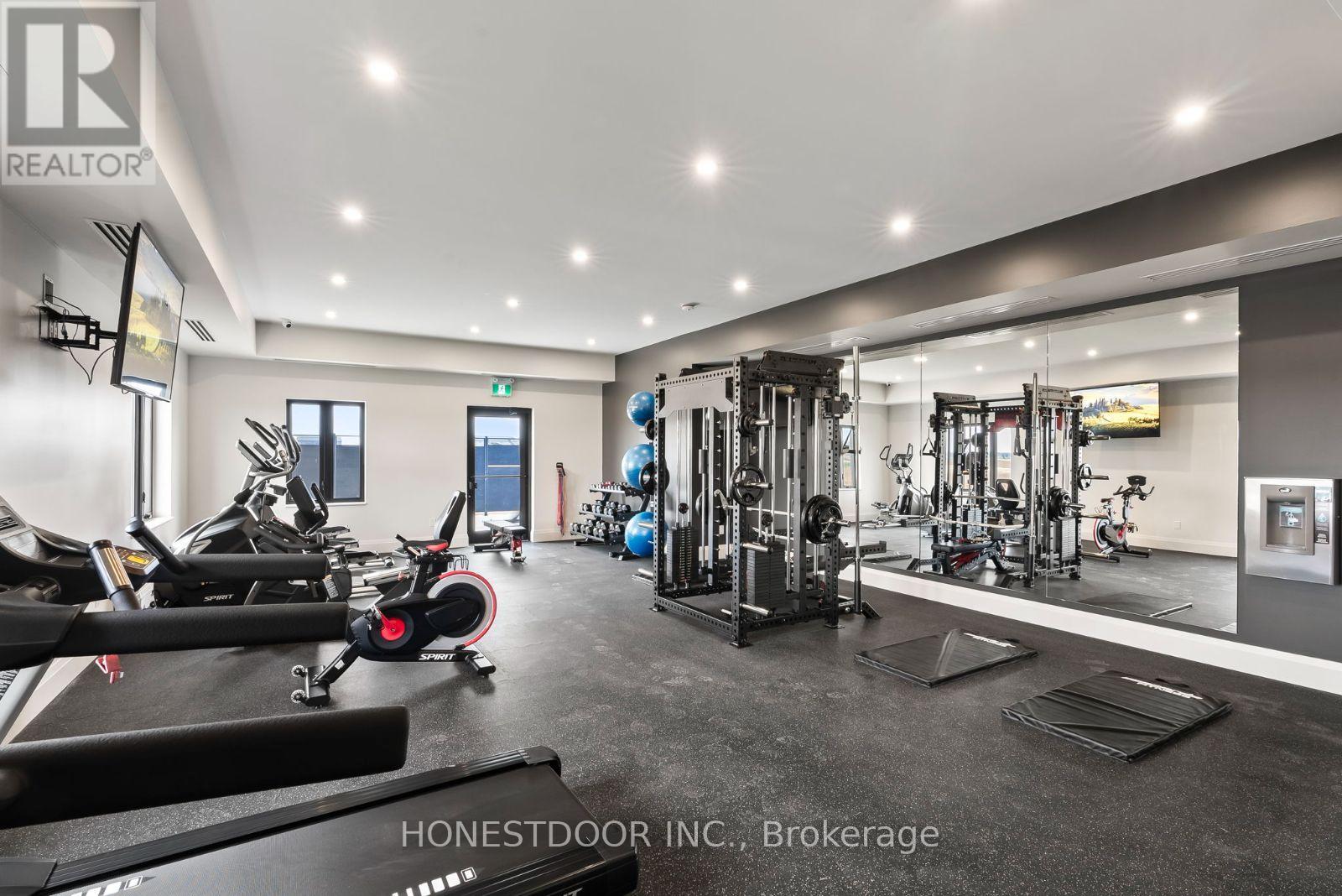 A gym with a variety of equipment including treadmills, weights, and exercise machines.