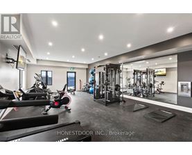 A gym with a variety of equipment including treadmills, weights, and exercise machines.