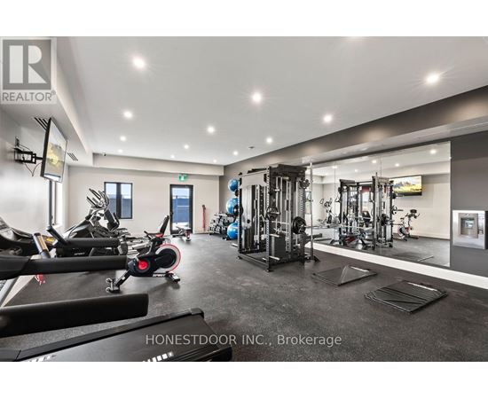 A gym with a variety of equipment including treadmills, weights, and exercise machines.