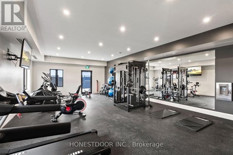 A gym with a variety of equipment including treadmills, weights, and exercise machines.