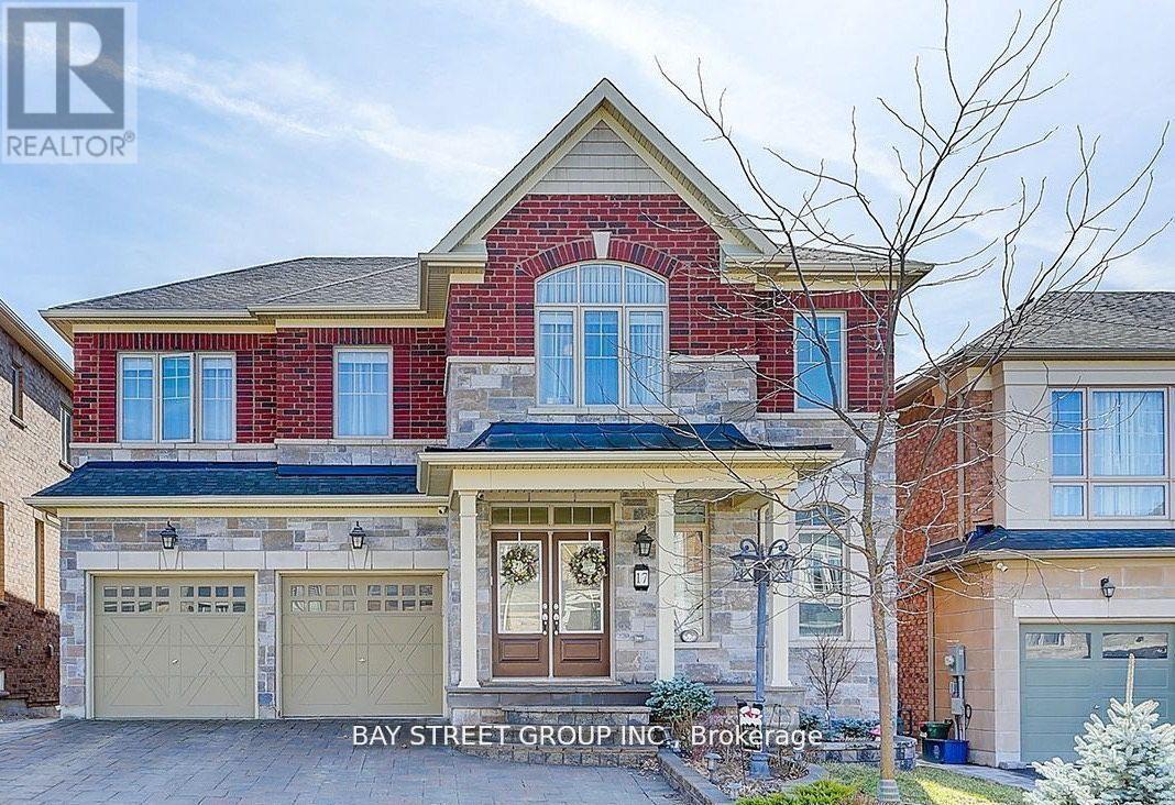 A two-story house with a red brick facade and a garage.