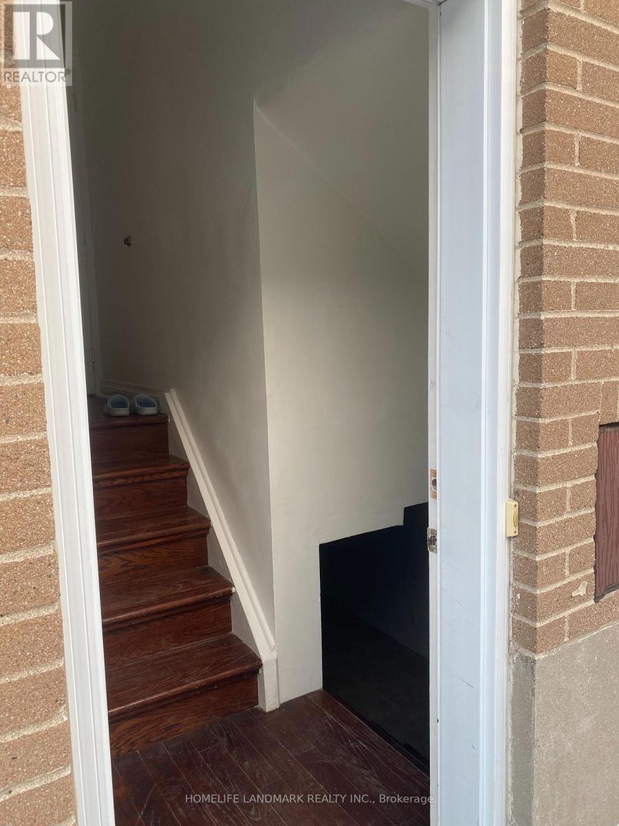 A hallway with a staircase leading to the second floor.