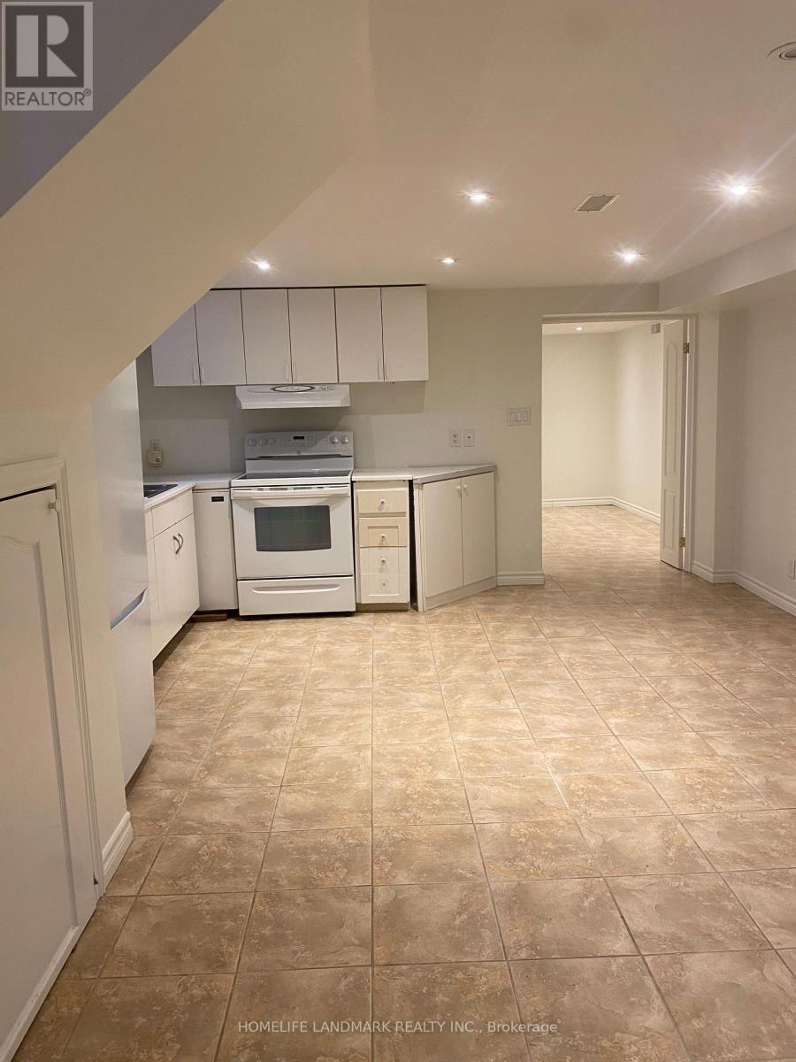 A kitchen with white appliances and cabinets.