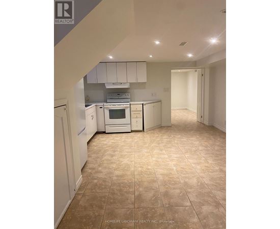 A kitchen with white appliances and cabinets.