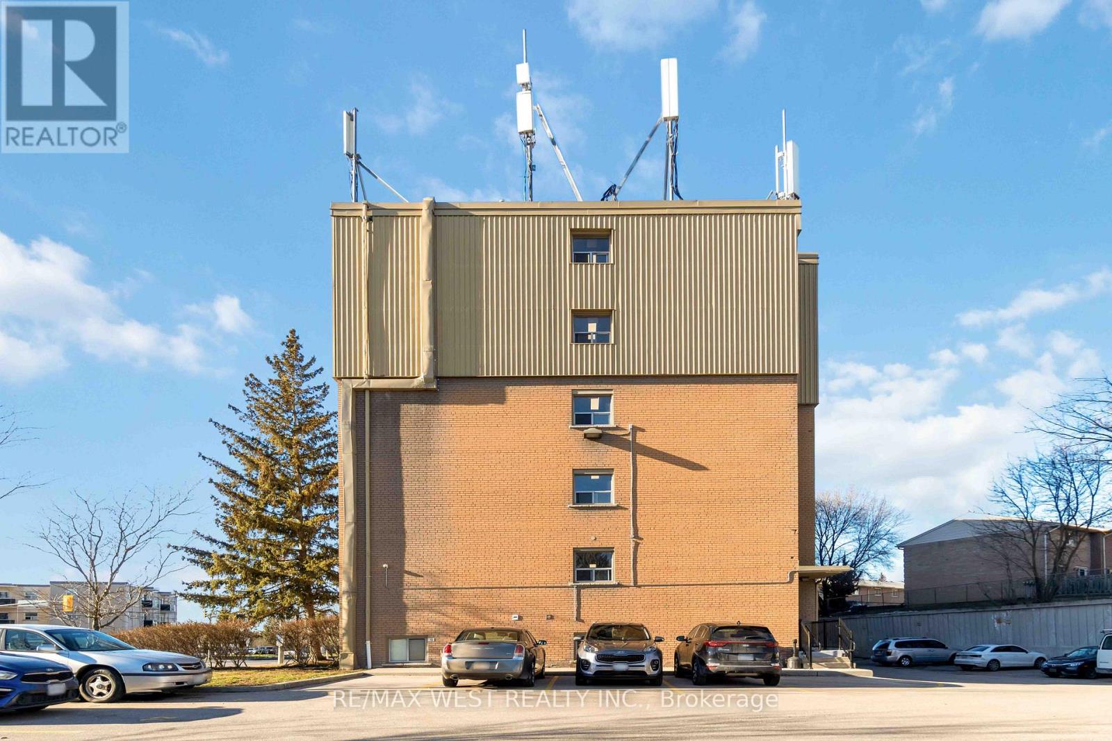 A large building with a parking lot in front of it.