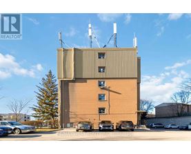 A large building with a parking lot in front of it.