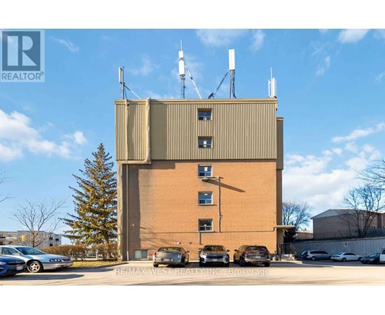 A large building with a parking lot in front of it.