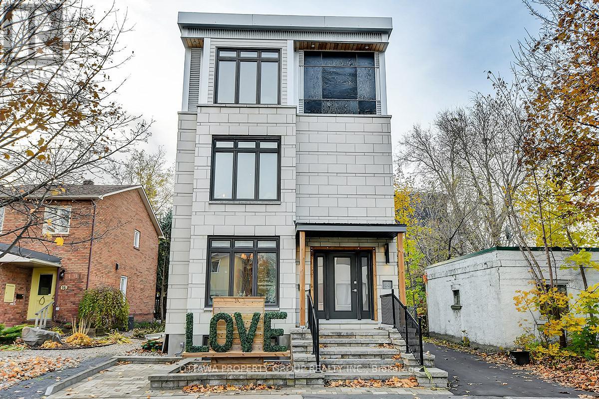 A house with the word LOVE spelled out in front of it.