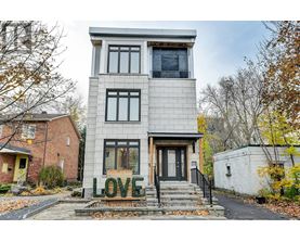 A house with the word LOVE spelled out in front of it.