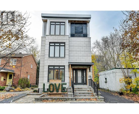A house with the word LOVE spelled out in front of it.