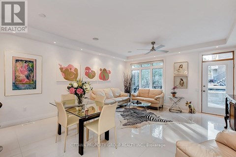 A living room with a glass dining table and chairs.