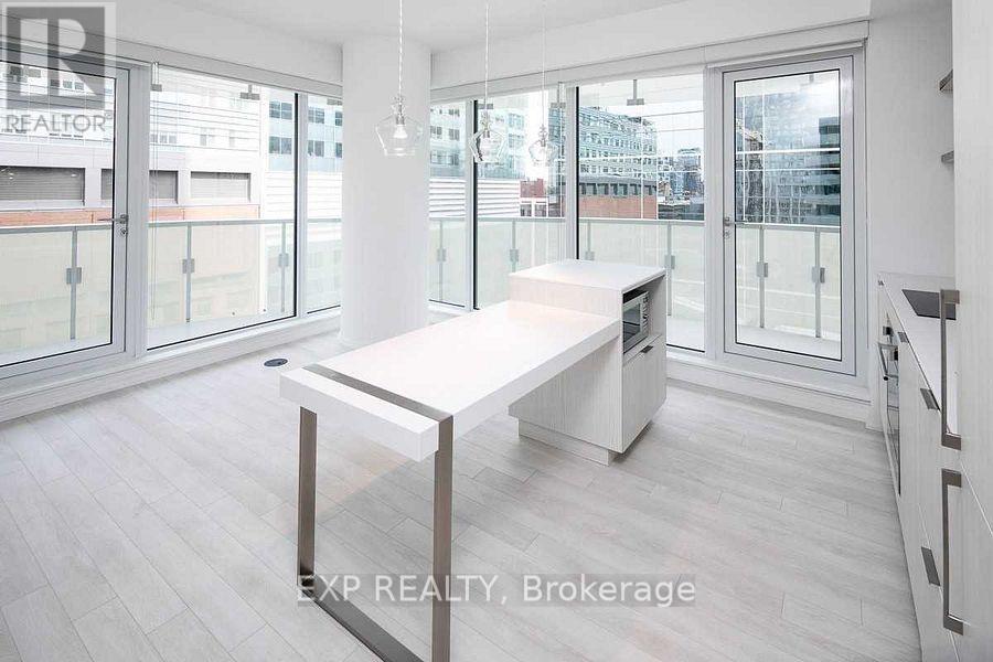 A spacious room with a long table and a view of the city through the windows.