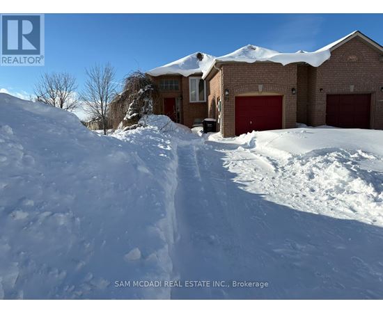 A house with a red garage door is surrounded by snow.