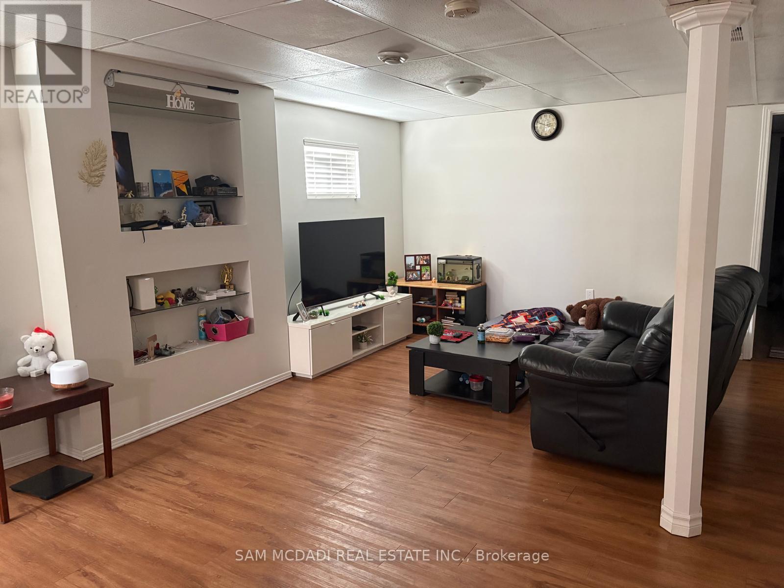 A living room with a TV, a couch, and a coffee table.