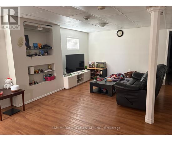 A living room with a TV, a couch, and a coffee table.