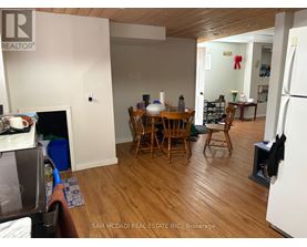 A kitchen with a table and chairs in the middle of the room.
